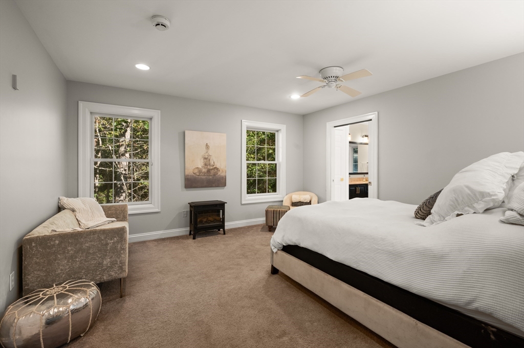 27 Turtle Back Road Essex, MA 01929 - Photo 14 of 40 a spacious bedroom with a bed and glass window