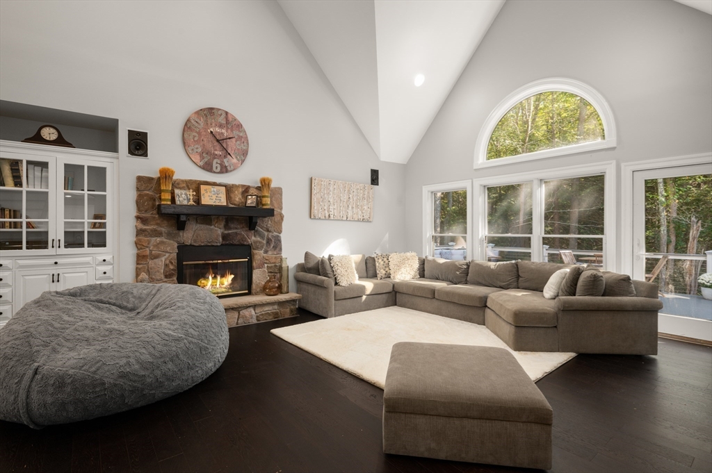 27 Turtle Back Road Essex, MA 01929 - Photo 17 of 40 a living room with furniture a fireplace and a large window