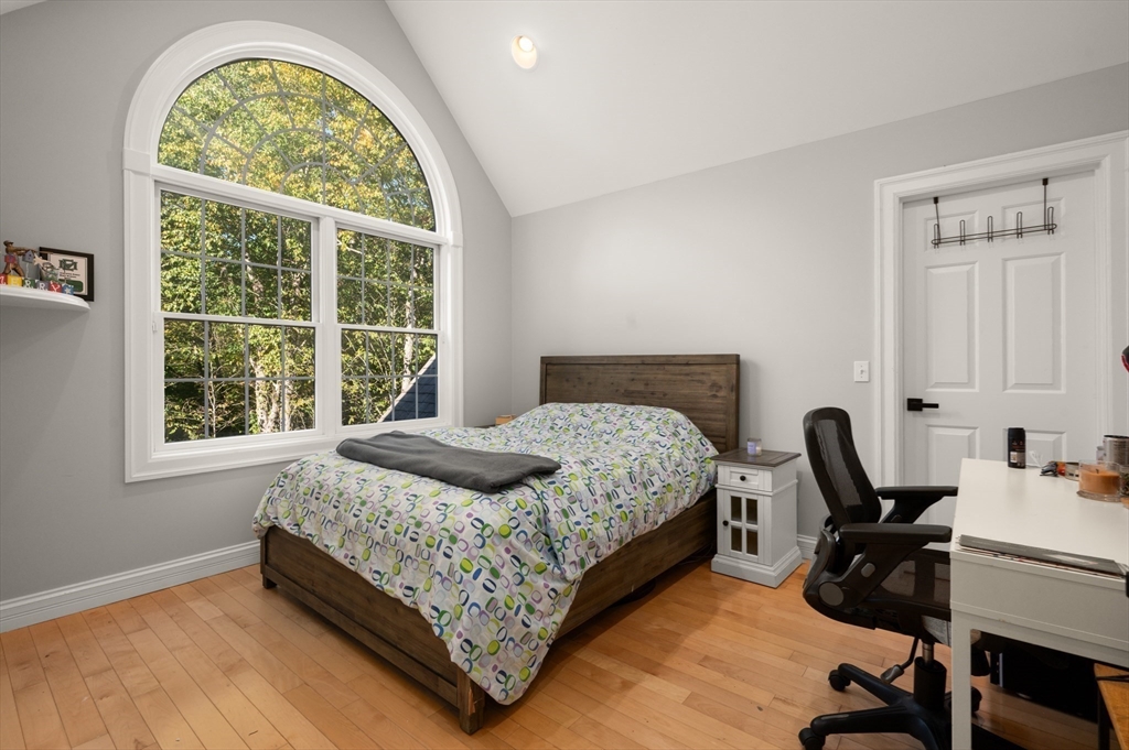 27 Turtle Back Road Essex, MA 01929 - Photo 21 of 40 a bedroom with a bed a desk and chair with window