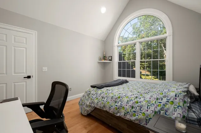 a bedroom with a bed and a large window