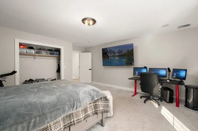 a bedroom with a bed couch and window