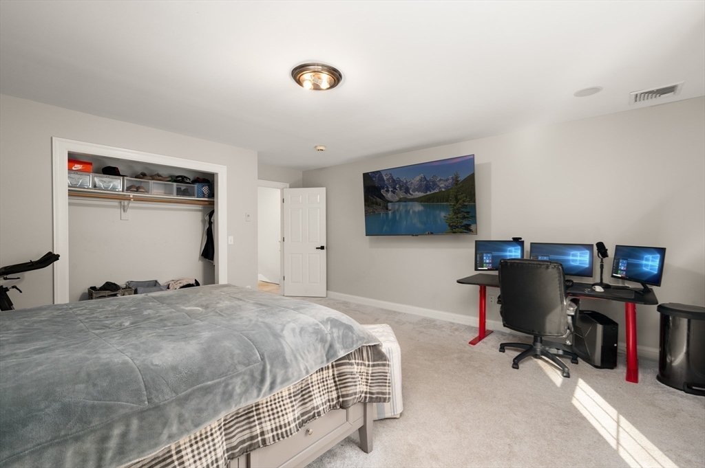 27 Turtle Back Road Essex, MA 01929 - Photo 26 of 40 a bedroom with a bed and a flat screen tv