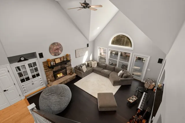 a living room with furniture large window and a fireplace