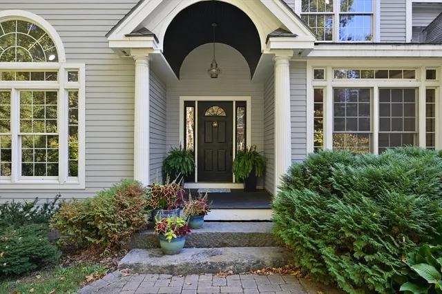 a front view of a house with a garden