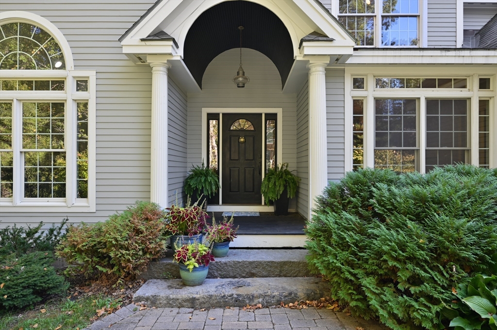 27 Turtle Back Road Essex, MA 01929 - Photo 3 of 40 a front view of a house with a garden
