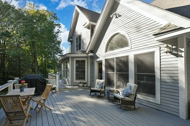 a view of a patio with couches chairs and wooden floor