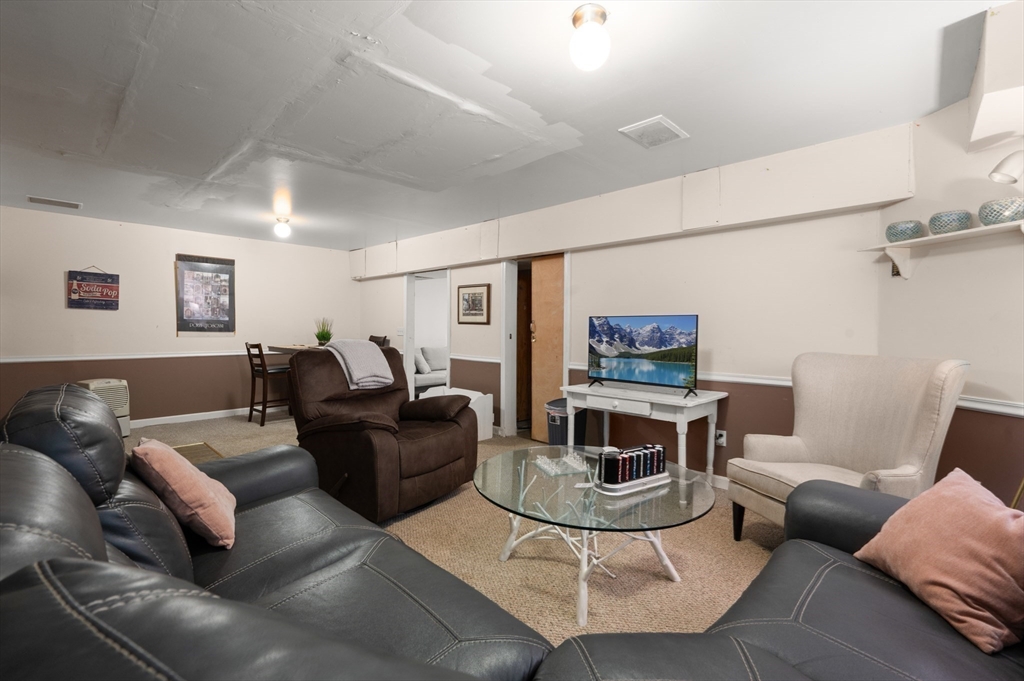 27 Turtle Back Road Essex, MA 01929 - Photo 38 of 40 a living room with furniture and a wooden floor