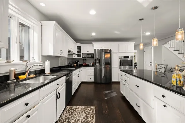 a large kitchen with stainless steel appliances lots of counter top space