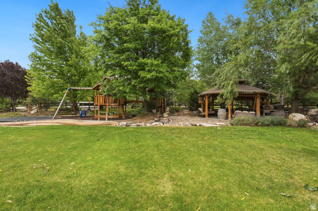 672 Perry Hollow Drive Mapleton, UT 84664 - Photo 97 of 106 Expansive green lawn with a wooden gazebo and a separate playset structure