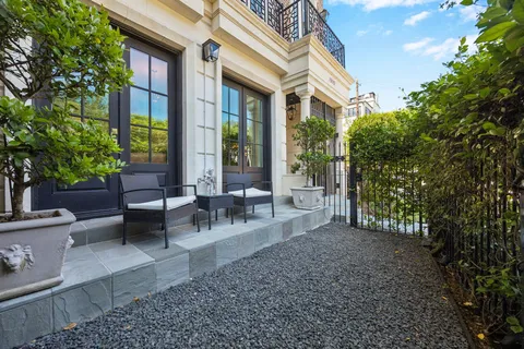 a view of a patio with table and chairs and potted plants