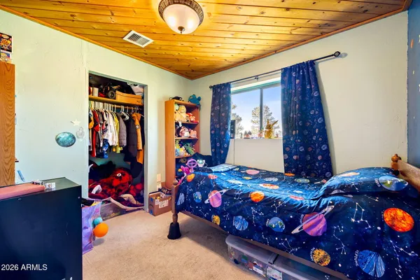 a bedroom with two beds and a large window