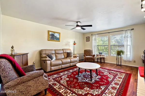 a living room with furniture a rug and a large window