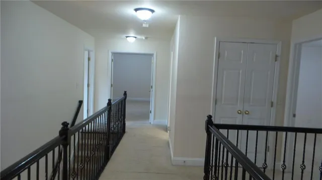 a kitchen with stainless steel appliances granite countertop a sink a stove a refrigerator and island with wooden floor