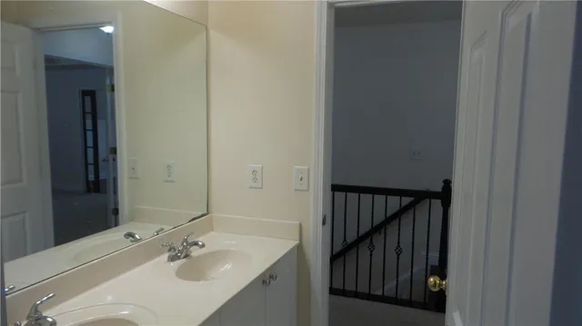 a view of an empty room and chandelier fan