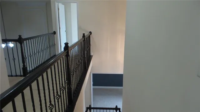 a spacious bathroom with a shower a sink and a large mirror