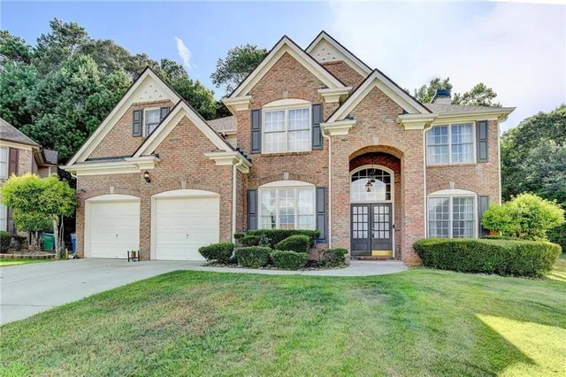 a bathroom with a sink mirror vanity toilet and bathtub