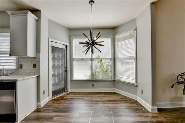 a kitchen with appliances a refrigerator and cabinets