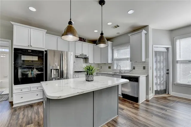 a view of a room with wooden floor and a window