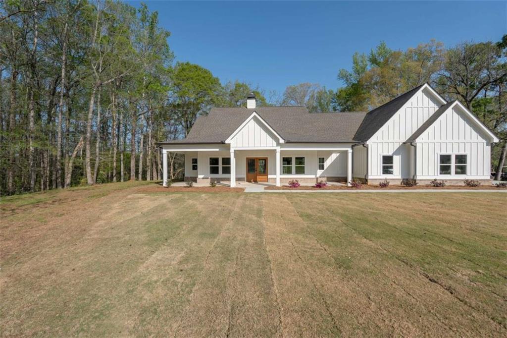 11691 Hazelbrand Road Northeast Covington, GA 30014 - Photo 4 of 53 a front view of a house with a garden