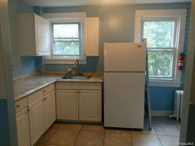 a white refrigerator freezer sitting inside of a kitchen