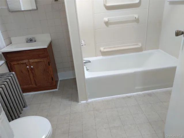 a bathroom with a sink a toilet and bathtub