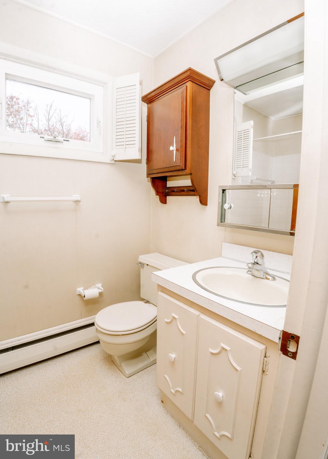 104 Rose Court Reading, PA 19607 - Photo 14 of 28 a bathroom with a sink a toilet and mirror