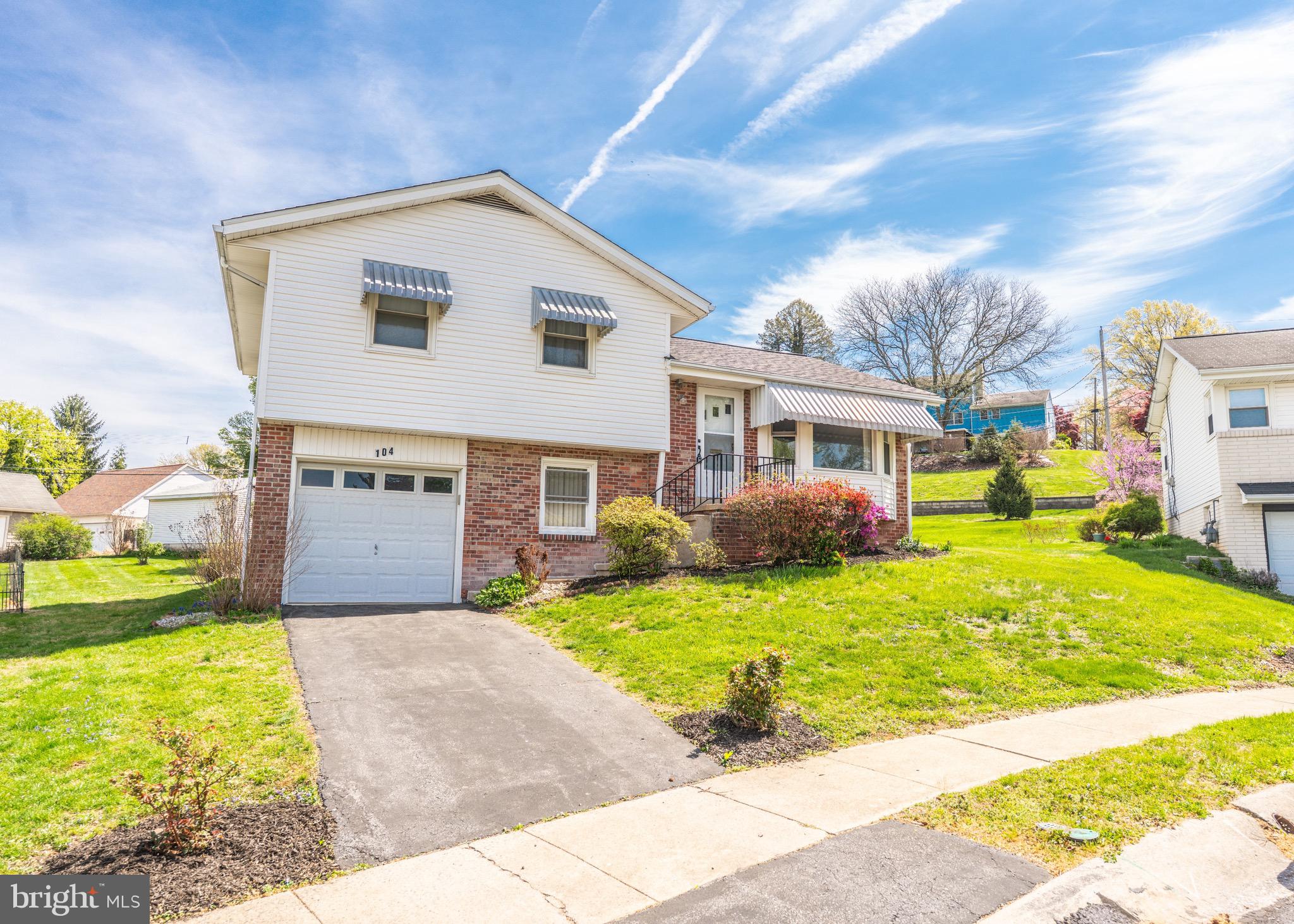 104 Rose Court Reading, PA 19607 - Photo 2 of 28 a front view of a house with a garden and yard