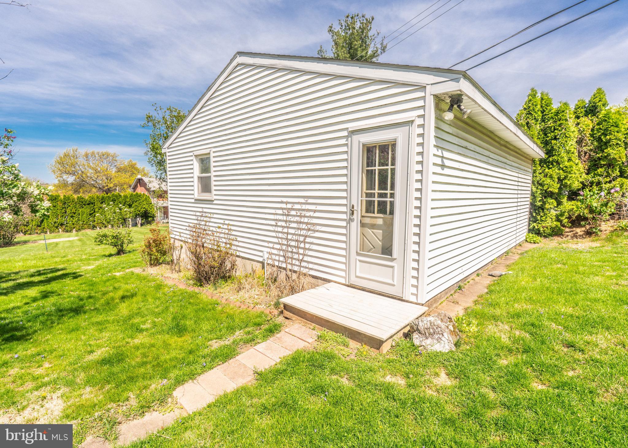104 Rose Court Reading, PA 19607 - Photo 26 of 28 a view of a white house with a yard and a large tree