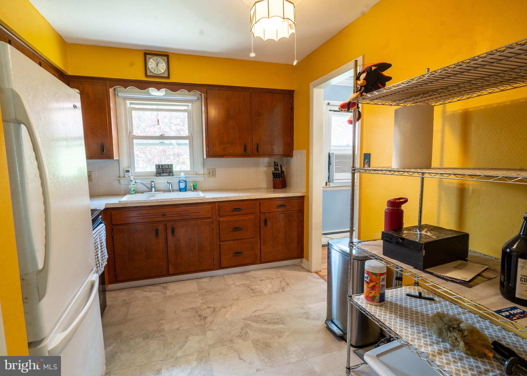 104 Rose Court Reading, PA 19607 - Photo 8 of 28 a kitchen with sink a refrigerator and cabinets