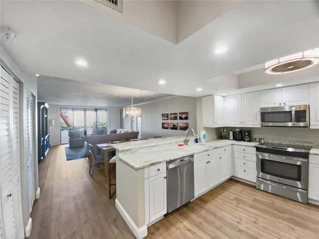 a large kitchen with stainless steel appliances lots of counter top space