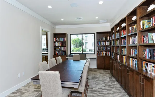 a view of a dining room with furniture and a book shelf
