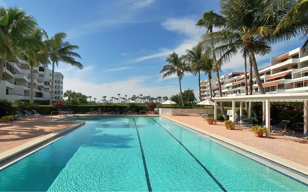 a view of swimming pool with outdoor seating and city view
