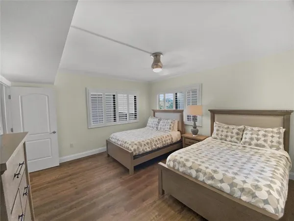 a bedroom with two beds and painting on the wall