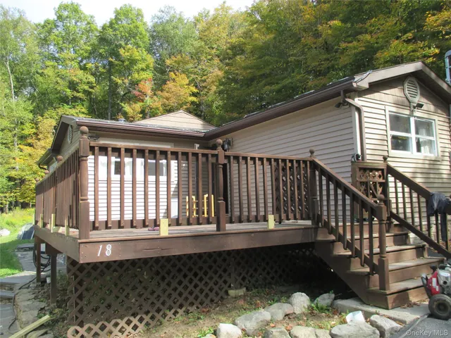 a view of a wooden house with a yard