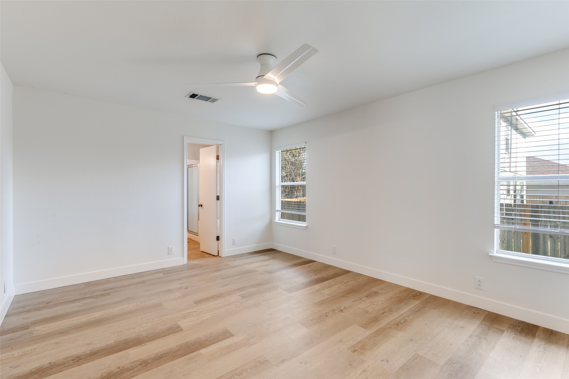 109 Orange Tree Lane Georgetown, TX 78626 - Photo 14 of 25 a view of an empty room with wooden floor and a window