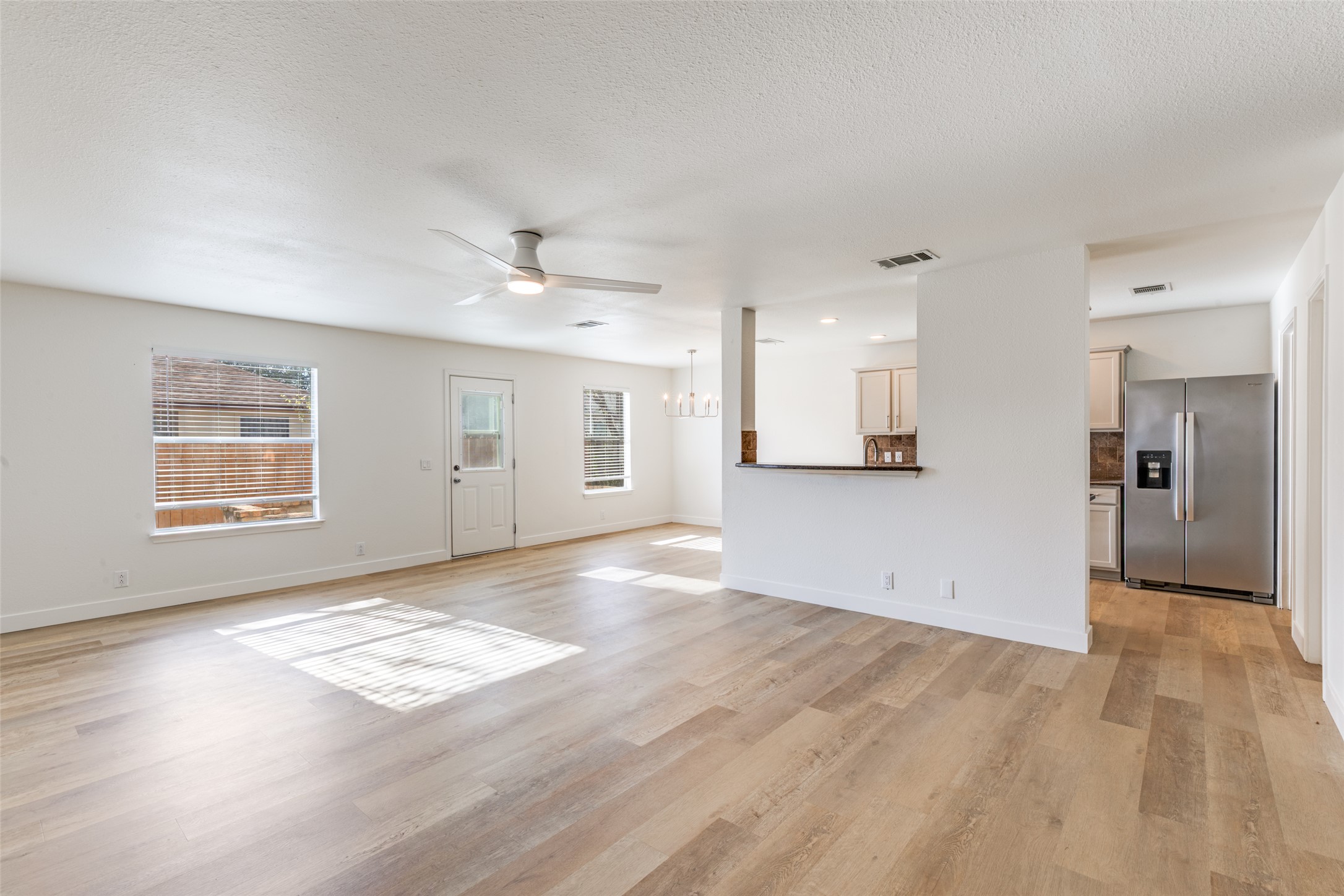 109 Orange Tree Lane Georgetown, TX 78626 - Photo 4 of 25 an empty room with wooden floor and windows