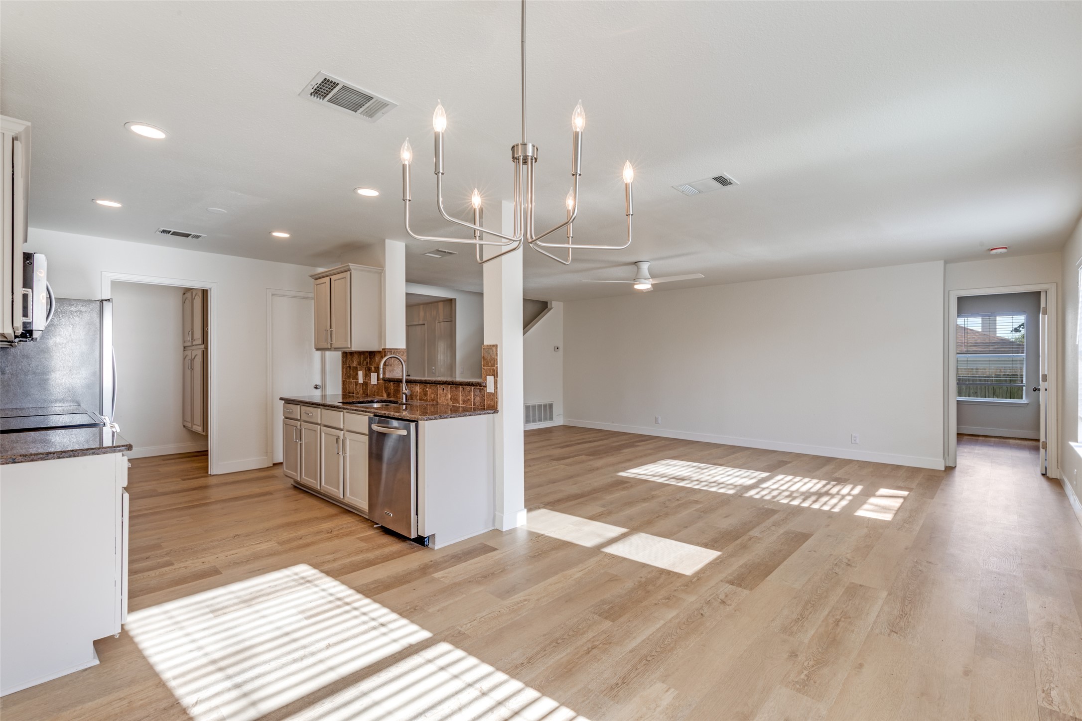 109 Orange Tree Lane Georgetown, TX 78626 - Photo 7 of 25 a large kitchen with granite countertop a large counter top and stainless steel appliances