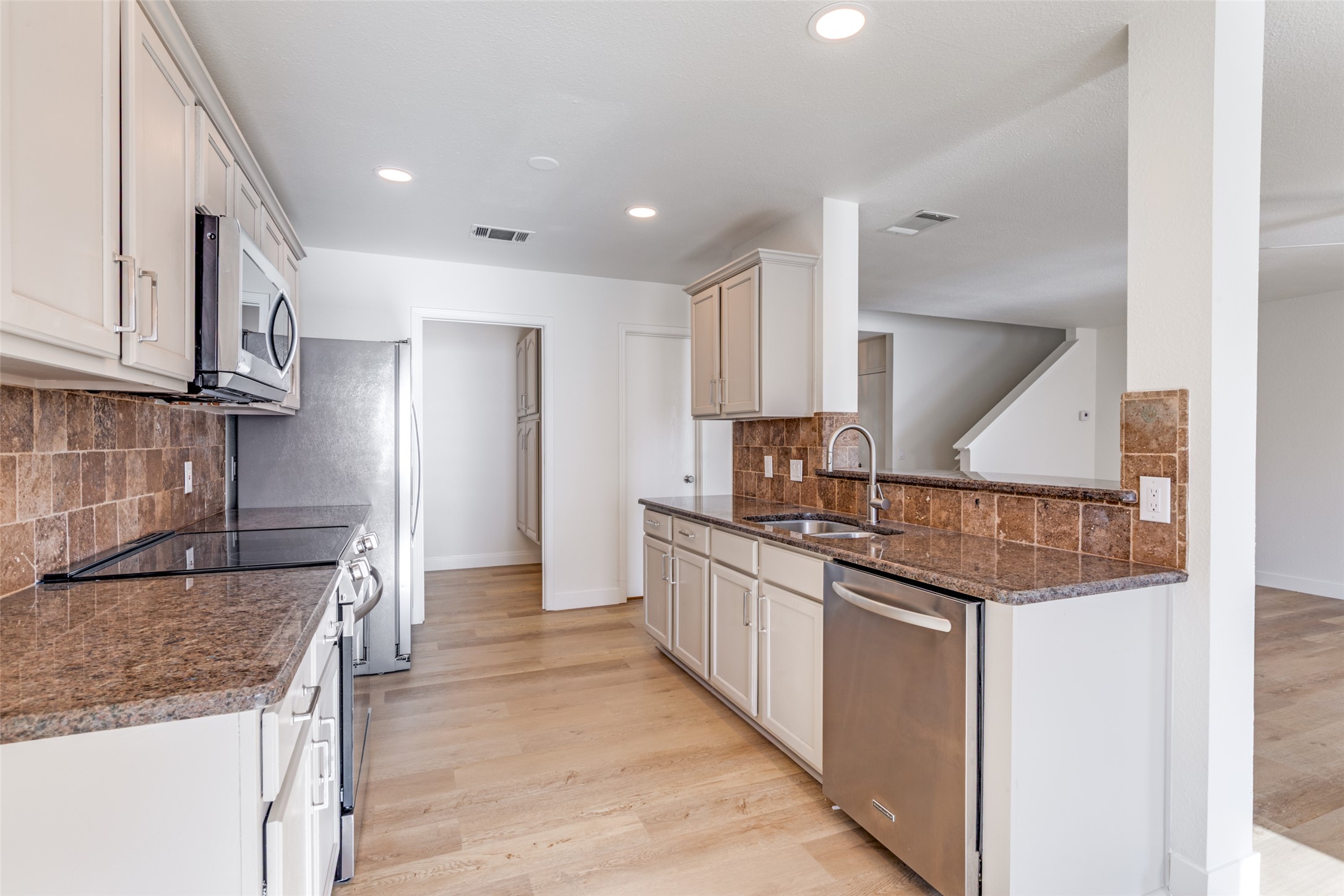109 Orange Tree Lane Georgetown, TX 78626 - Photo 8 of 25 a kitchen with stainless steel appliances granite countertop a sink and a stove