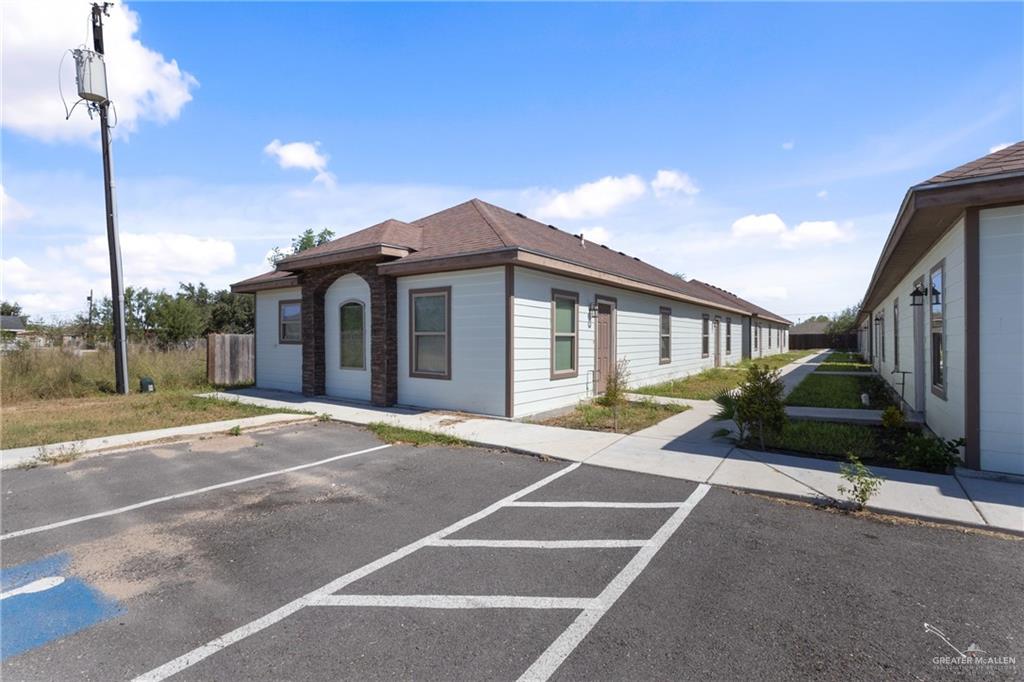 340 Eva Street, Unit 2 Elsa, TX 78543 - Photo 2 of 12 a front view of a house with a garden