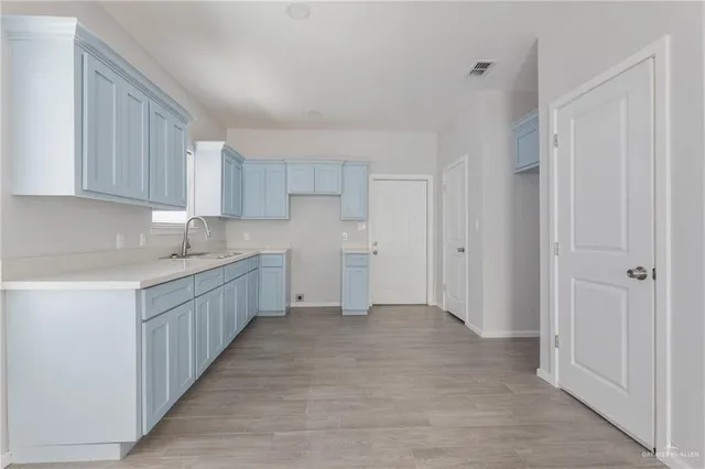 a kitchen with white cabinets