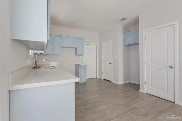 a kitchen with a sink and a refrigerator