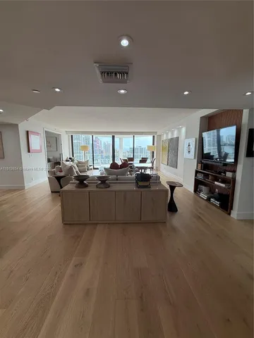 a bedroom with furniture and a large window