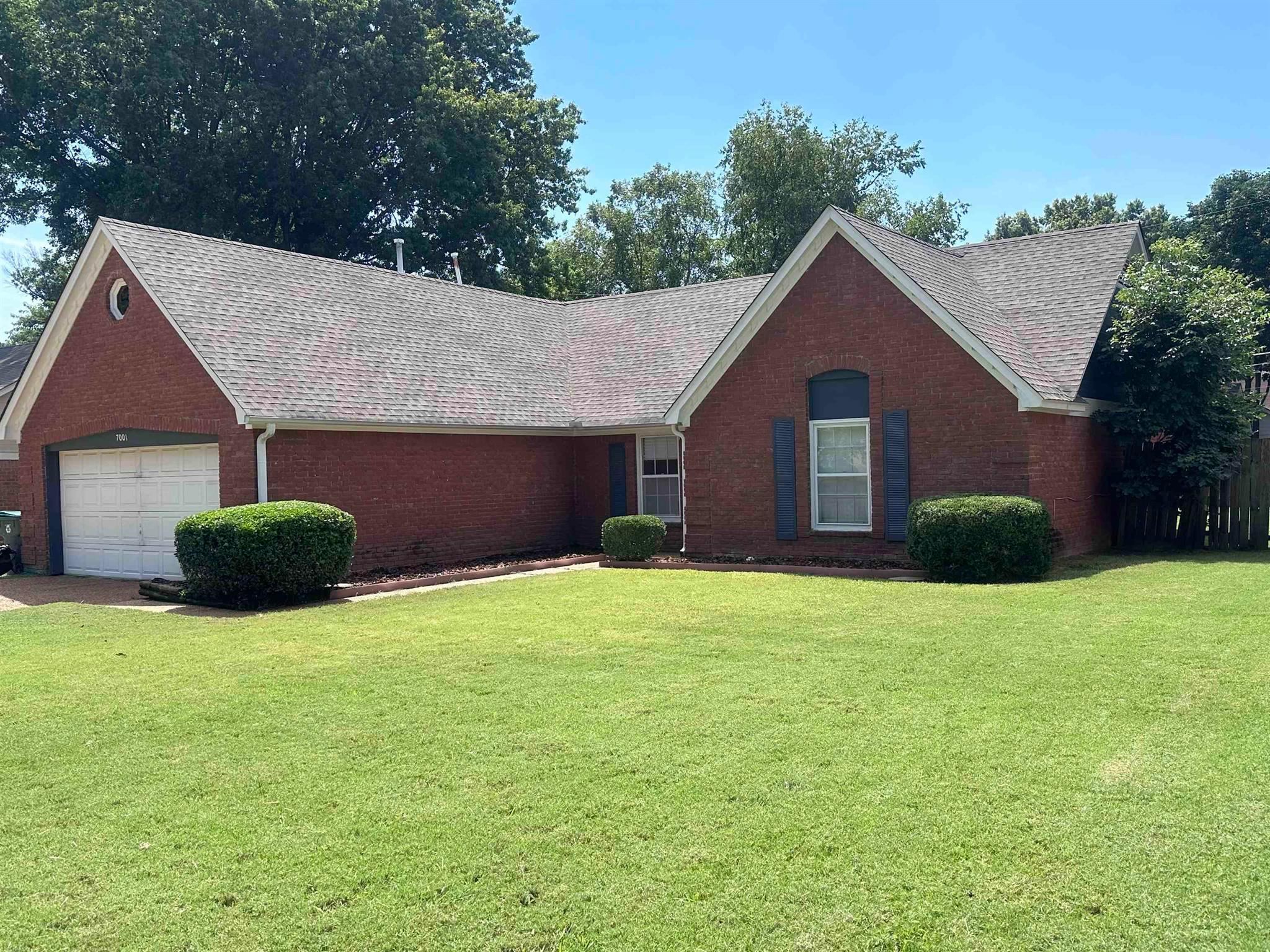 7001 Rockingham Road Memphis, TN 38125 - Photo 1 of 9 a view of a house with a yard and garage