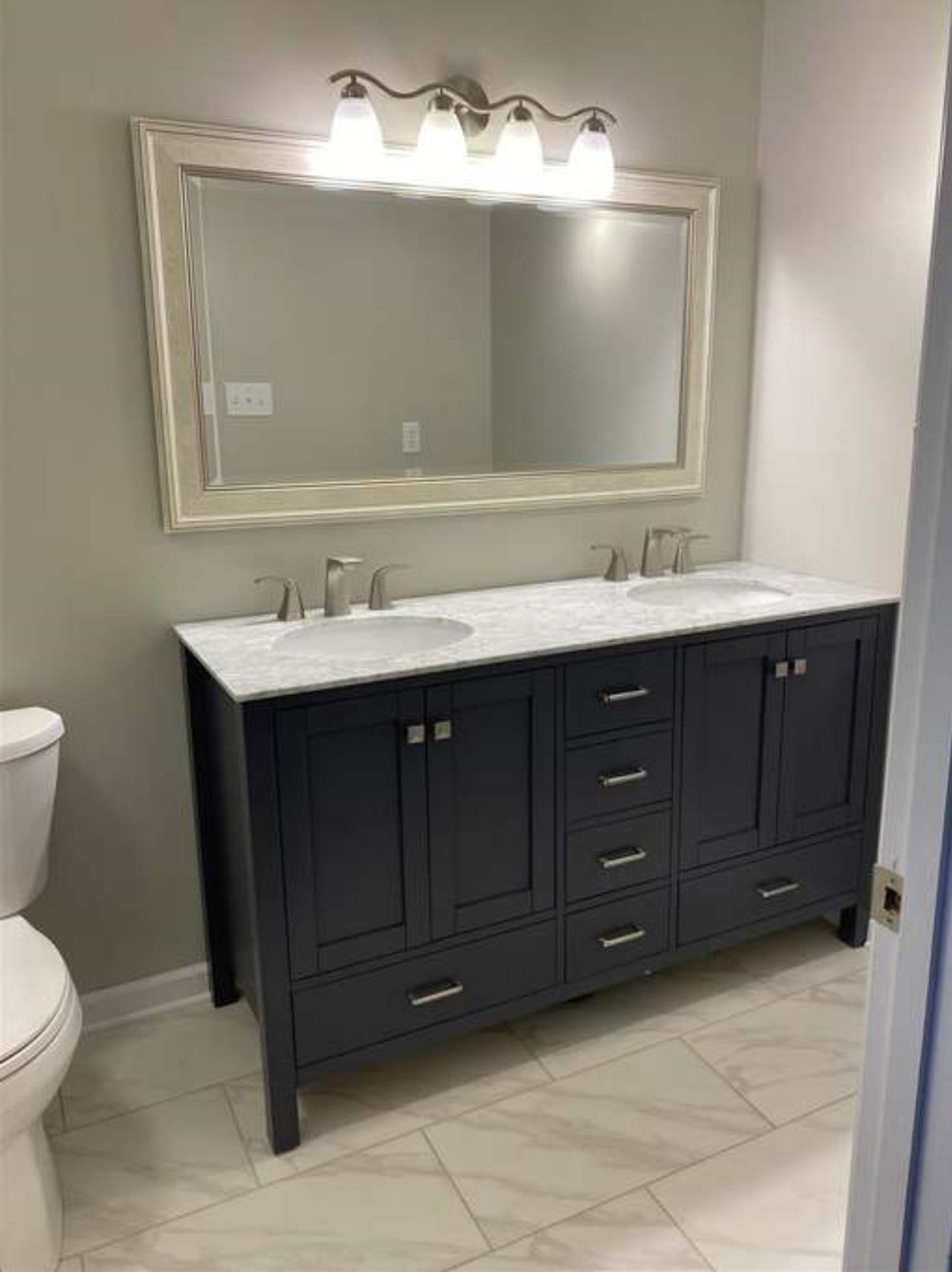 7001 Rockingham Road Memphis, TN 38125 - Photo 4 of 9 a bathroom with a toilet sink and mirror