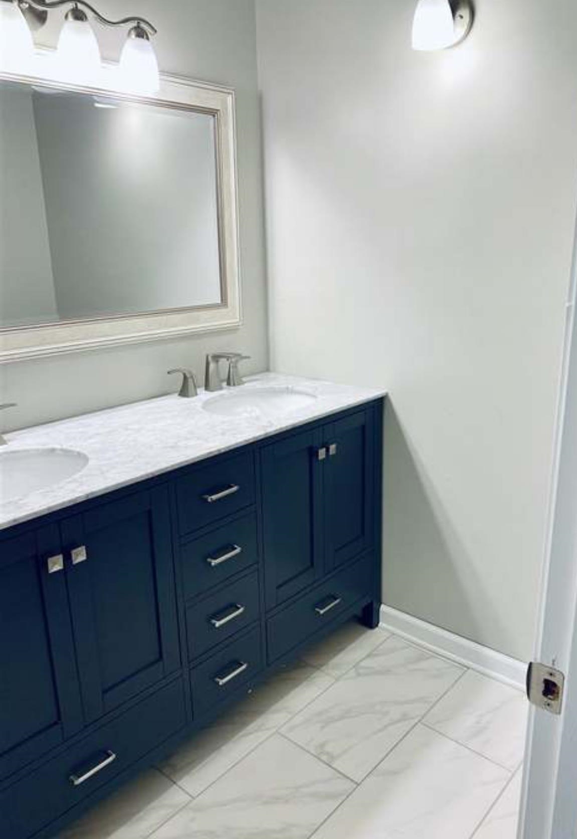 7001 Rockingham Road Memphis, TN 38125 - Photo 5 of 9 a bathroom with a sink vanity and mirror