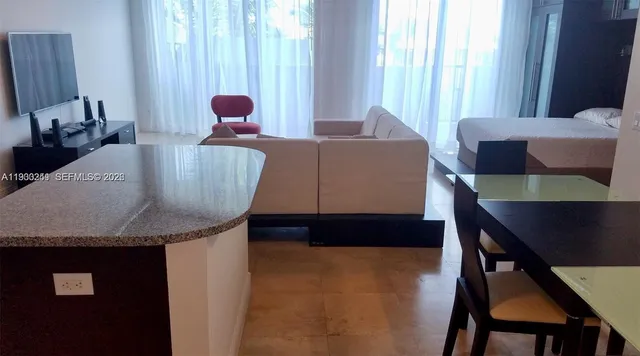 a living room with furniture and a large window