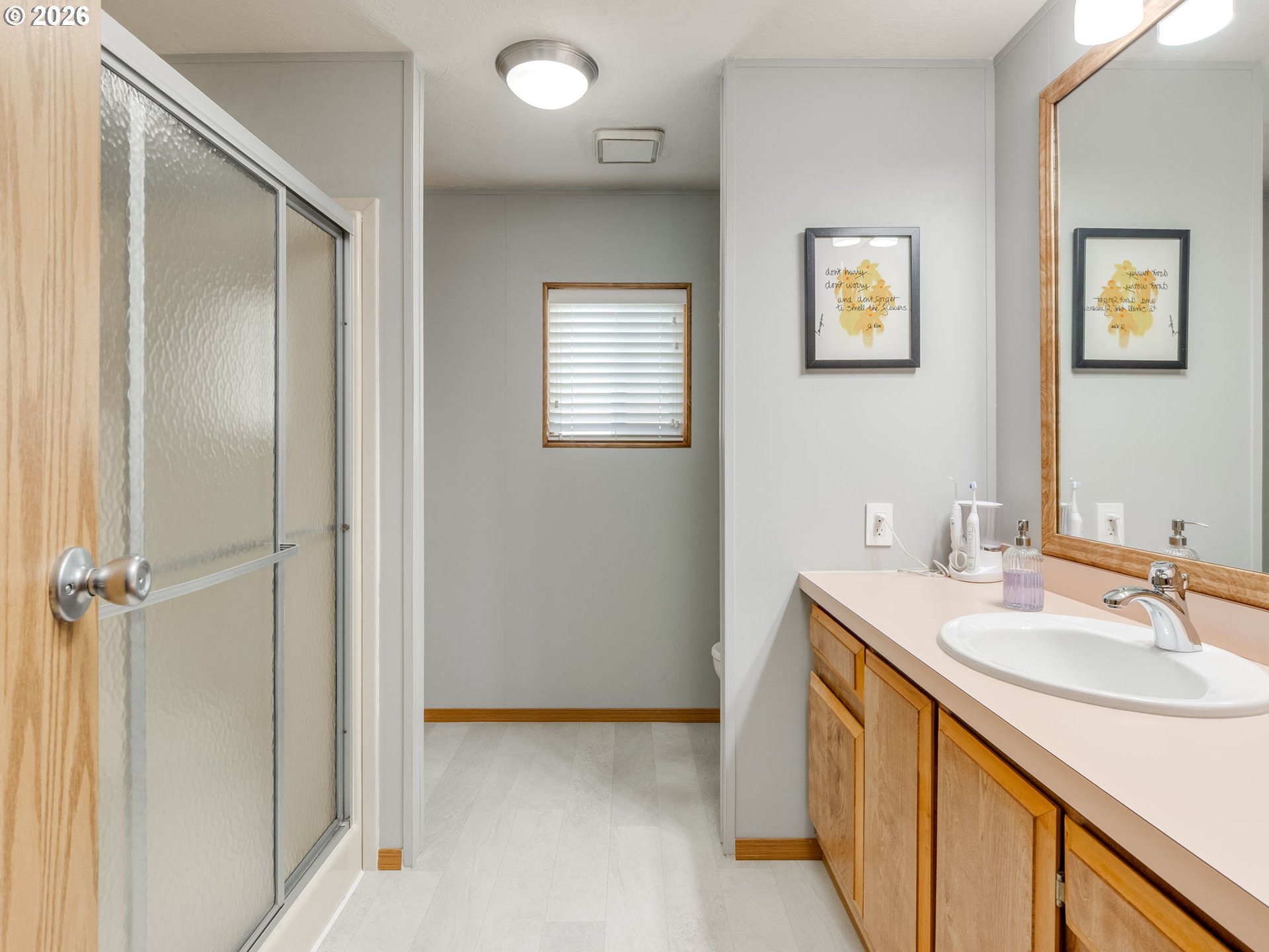4730 Auburn Road Northeast, Unit 125 Salem, OR 97301 - Photo 24 of 36 a bathroom with a sink a mirror and a shower