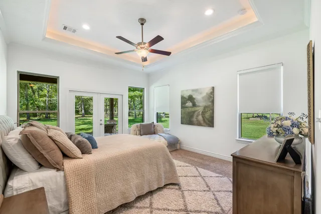a bed room with a bed and a large window