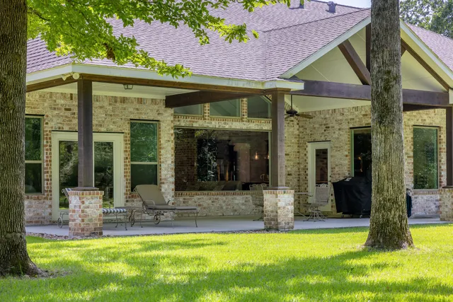 a view of a house with swimming pool and a porch