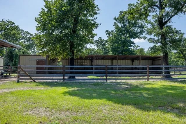 a view of an swimming pool and trees in the background